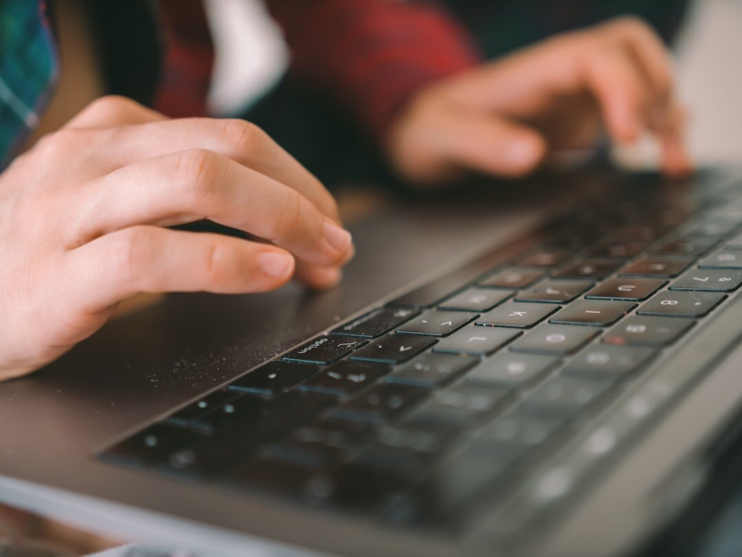 writer typing on laptop